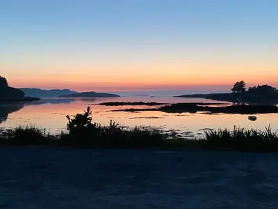 a sunset over a body of water at Bunessan Inn in Bunessan