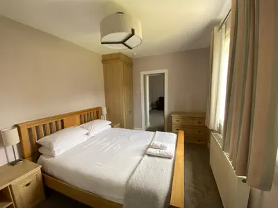 a bedroom with a large bed and a window at Bunessan Inn in Bunessan