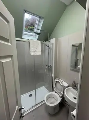 a bathroom with a shower and a toilet and a sink at Carronvale. 3 Bedroom Oban Apartment. in Oban