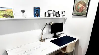 a desk with a computer on a white wall at La Casita, Your Home Away from Home - Free Parking in Glasgow