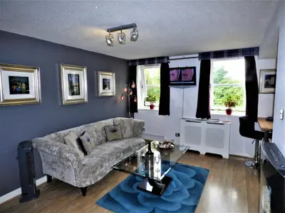 a living room with a couch and a table at Grassmarket Studio in Edinburgh