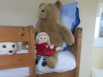 two large teddy bears sitting on a bunk bed at Uplawmoor in Uplawmoor