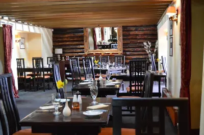 a dining room with tables and chairs in a restaurant at Uplawmoor in Uplawmoor