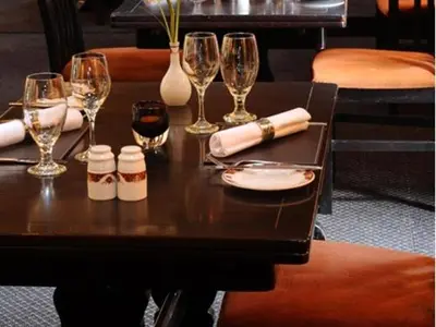 a table with wine glasses and wine bottles on it at Uplawmoor in Uplawmoor