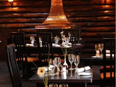 a table with wine glasses and flowers on it at Uplawmoor in Uplawmoor