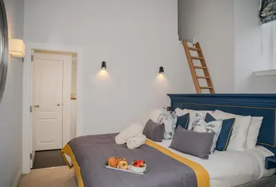 a bed with two dogs on a tray on it at The Kinross Residence in Kinross