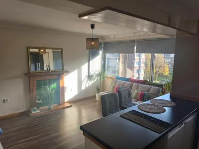 a kitchen and living room with a couch and a table at Open space studio in Shawlands in Glasgow