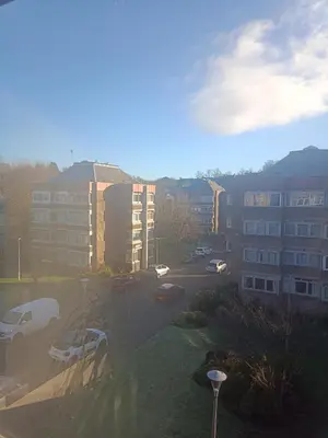 a view of a parking lot with buildings and cars at Open space studio in Shawlands in Glasgow