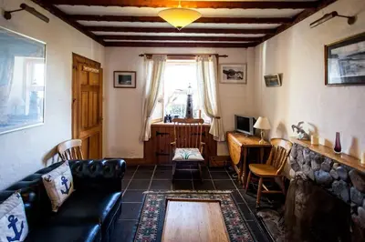 a living room with a couch and a table at Seaview Cottage in Isle of Jura