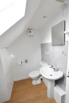 a white bathroom with a toilet and a sink at Argyll House Ben More in Salen