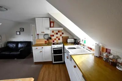 a kitchen with a sink and a stove top oven at Argyll House Ben More in Salen
