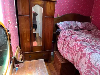 a bedroom with a bed and a dresser with a mirror at Very central 2 bedroom flat in World Heritage Site in Edinburgh