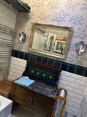 a bathroom with a sink and a mirror on the wall at Very central 2 bedroom flat in World Heritage Site in Edinburgh