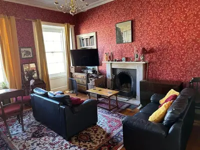 a living room with two couches and a fireplace at Very central 2 bedroom flat in World Heritage Site in Edinburgh