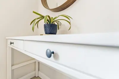 a white dresser with a plant on top at The Merchants Gem - 2Bed & Free Parking in Glasgow