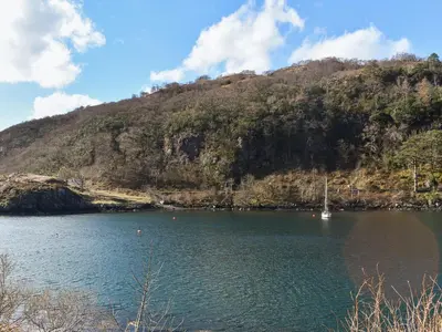 a large body of water with a mountain in the background at Bayview in Kentallen