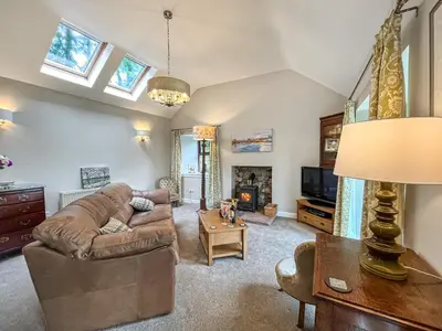 a living room with a couch and a table at The Clachan Bothy in Drumpark