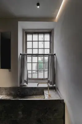 a bathroom with a sink and a window at Loggia Studio in Edinburgh