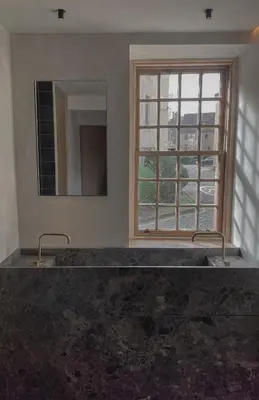 a bathroom with a large sink and a window at Loggia Studio in Edinburgh