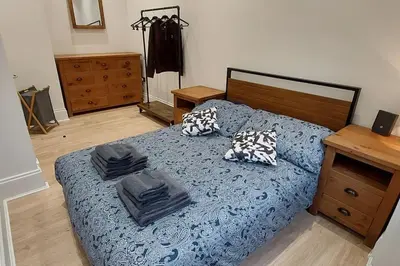 a bedroom with a bed with two pillows on it at Paisley Pattern Flat West End UWS UNI GLA Glasgow Airport in Elderslie