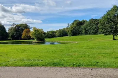 a park with a pond in the middle of a field at Paisley Pattern Flat West End UWS UNI GLA Glasgow Airport in Elderslie