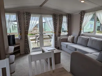 a living room with a couch and a tv at The Ardennes 66 in Dunoon