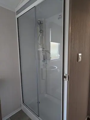 a shower with a glass door in a bathroom at The Ardennes 66 in Dunoon