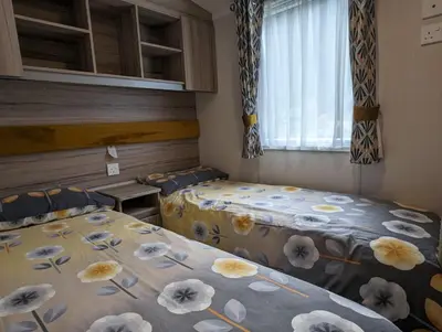 a room with two beds and a window at The Ardennes 66 in Dunoon