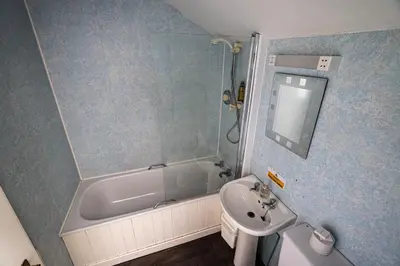 a bathroom with a sink and a tub and a toilet at Lochranza Country Inn in Lochranza