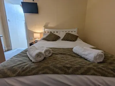 a bed with two towels on top of it at Lochranza Country Inn in Lochranza