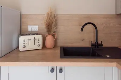a kitchen counter with a sink and a toaster at Grove House in Queensferry