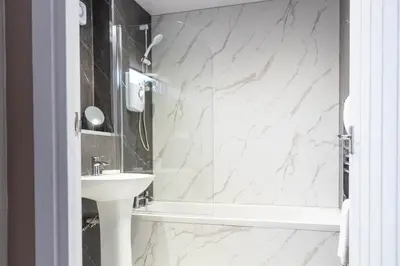 a bathroom with a sink and a shower at Grove House in Queensferry