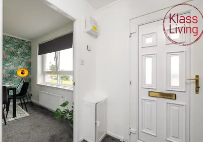 a white door in a room with a table at Aitkenhead house by Klass Living in Coatbridge