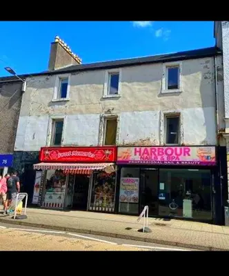 a store on the side of a street at Oban Lorne Apartment in Oban