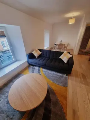 a living room with a couch and a table at Oban Lorne Apartment in Oban