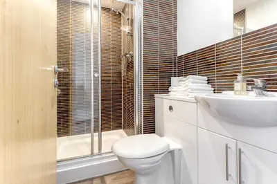 a bathroom with a toilet and a sink and a shower at SECC Hydro Executive 7 Apartment in Glasgow