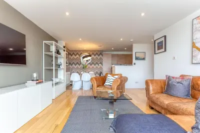 a living room with two couches and a tv at SECC Hydro Executive 7 Apartment in Glasgow