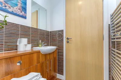 a bathroom with a sink and a mirror at SECC Hydro Executive 7 Apartment in Glasgow