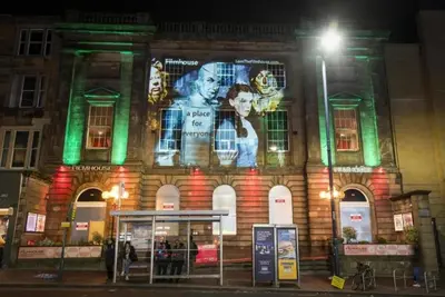 a building with a large advertisement on the side of it at 1 Bedrooms Flat in Central Edinburgh Haymarket, Heart of Edinburgh Flat Sleeps 4 in Edinburgh