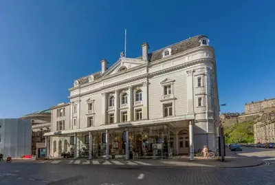 a large white building on the corner of a street at 1 Bedrooms Flat in Central Edinburgh Haymarket, Heart of Edinburgh Flat Sleeps 4 in Edinburgh