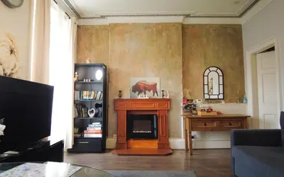a living room with a fireplace and a table at 1 Bedrooms Flat in Central Edinburgh Haymarket, Heart of Edinburgh Flat Sleeps 4 in Edinburgh