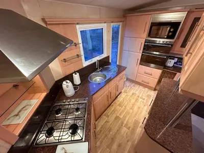 an overhead view of a kitchen with a stove and a sink at Atlas 2 Bedroom Caravan - Located in Uddingston, Glasgow at Maryville Caravan Site in Uddingston