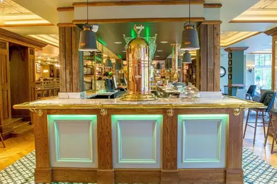a bar with green lights on top of it at Busby Hotel in Busby