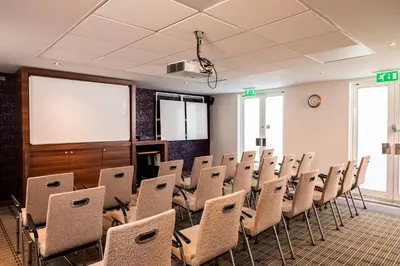 a conference room with chairs and a projection screen at Holiday Inn Express Stirling by IHG in Stirling