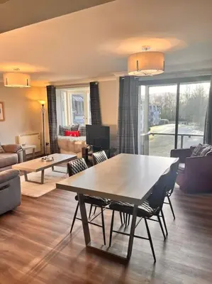 a living room with a table and chairs at Gleneagles Apartment in Auchterarder