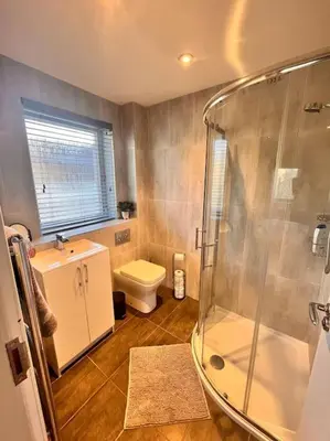 a bathroom with a shower and a toilet at Gleneagles Apartment in Auchterarder