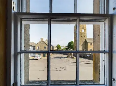 a view of a street from a window at The Old Post Office House in Perth