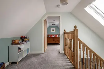 a attic room with a staircase and a bedroom at No7 Drummond Street, 2 bedrooms, Comrie in Comrie