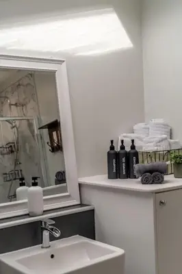 a bathroom with a sink and a mirror and towels at No7 Drummond Street, 2 bedrooms, Comrie in Comrie