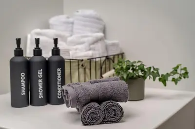 a bathroom counter with towels and a rack of towels at No7 Drummond Street, 2 bedrooms, Comrie in Comrie
